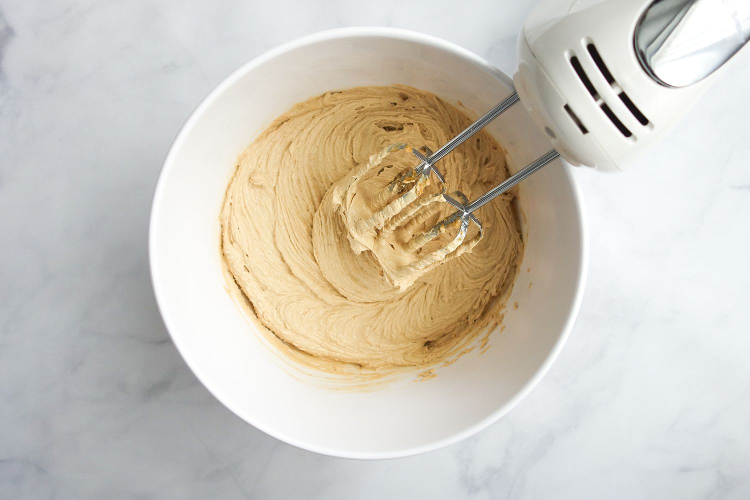 Wet Ingredients Whisked in a Bowl with an Handheld Whisk for Oatmeal Cookie Recipe 