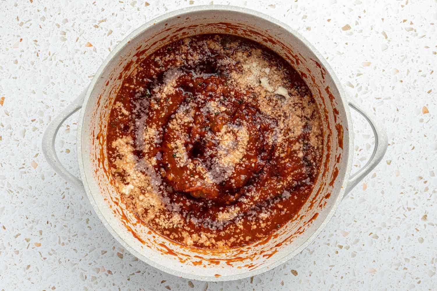 Red Wine and Parmesan Added to Pot of Sauce for Spaghetti and Meatballs Recipe