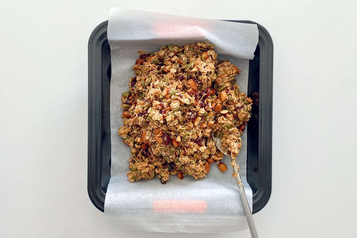 Mixture for Chewy Granola Bars in a square pan.