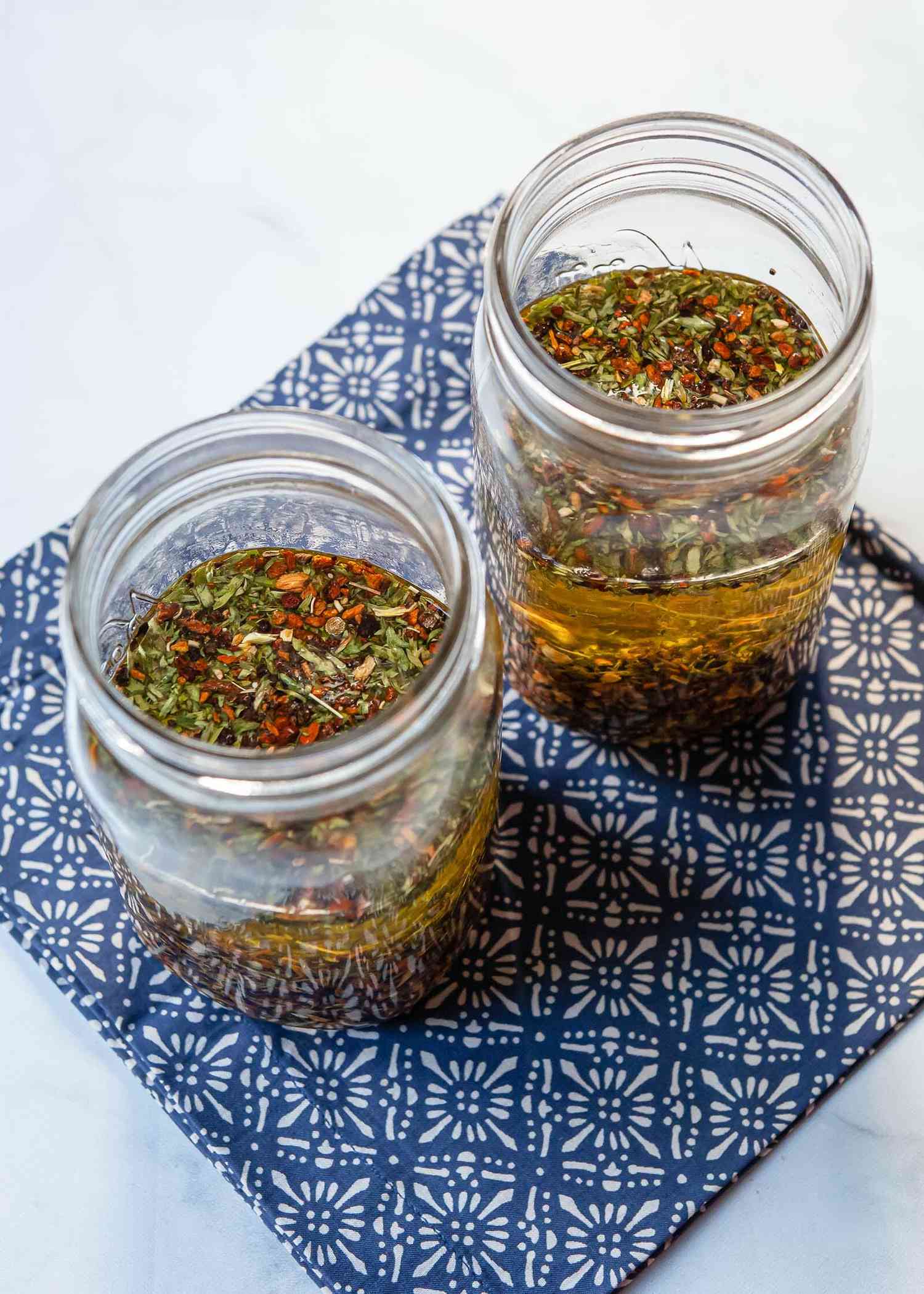 Two mason jars filled with ingredients for campari.