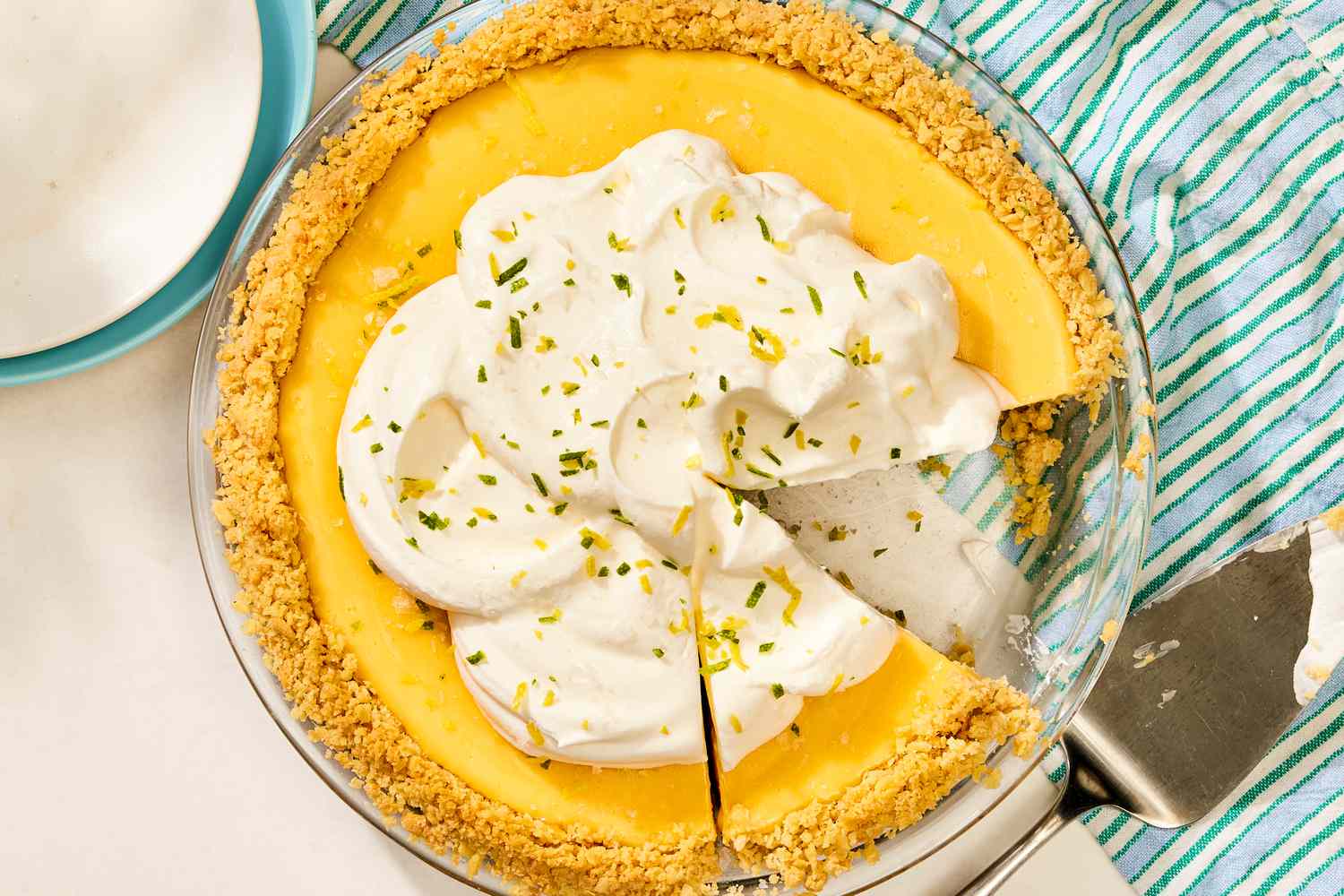 An Atlantic Beach pie with a graham cracker crust, topped with whipped cream, and partially sliced