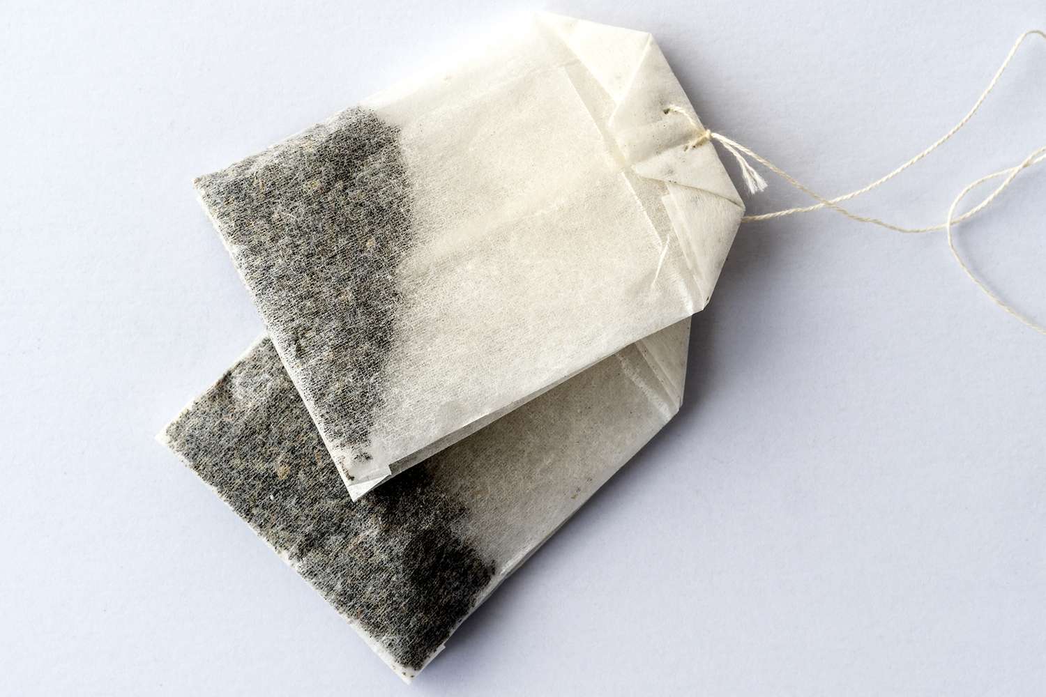 Two tea bags tied together with strings