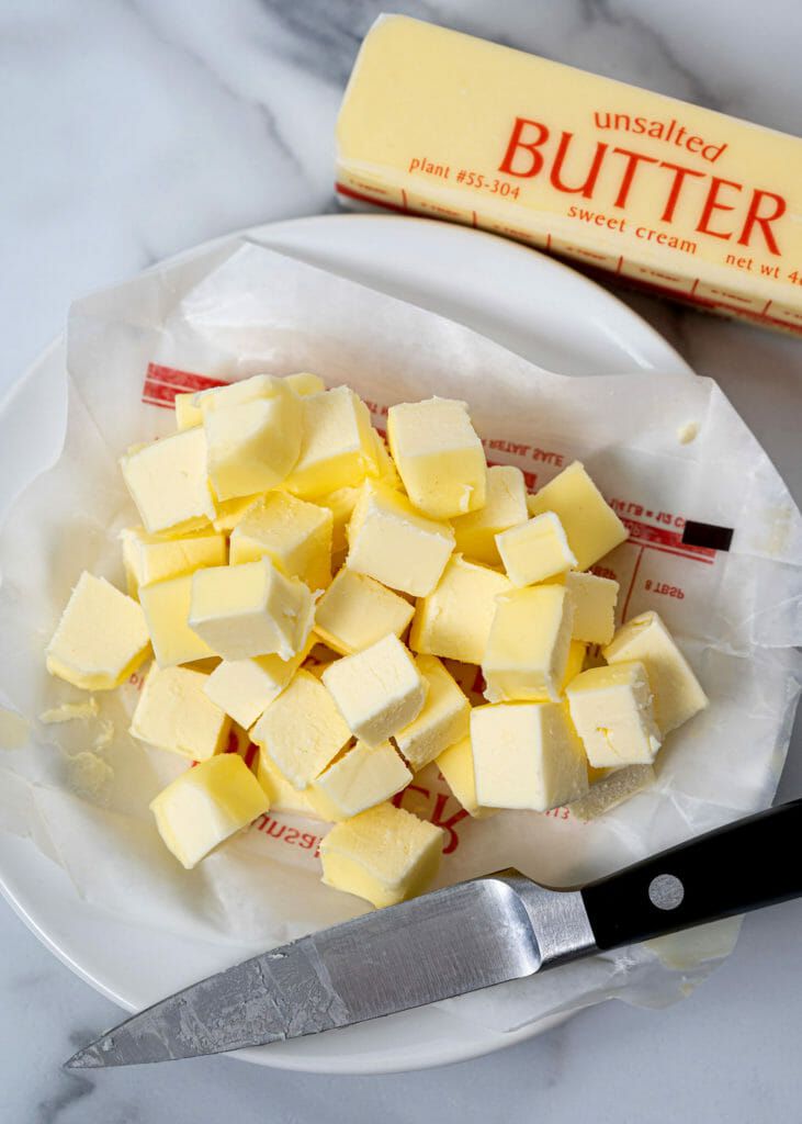 Unsalted butter stick and plate of cubed butter