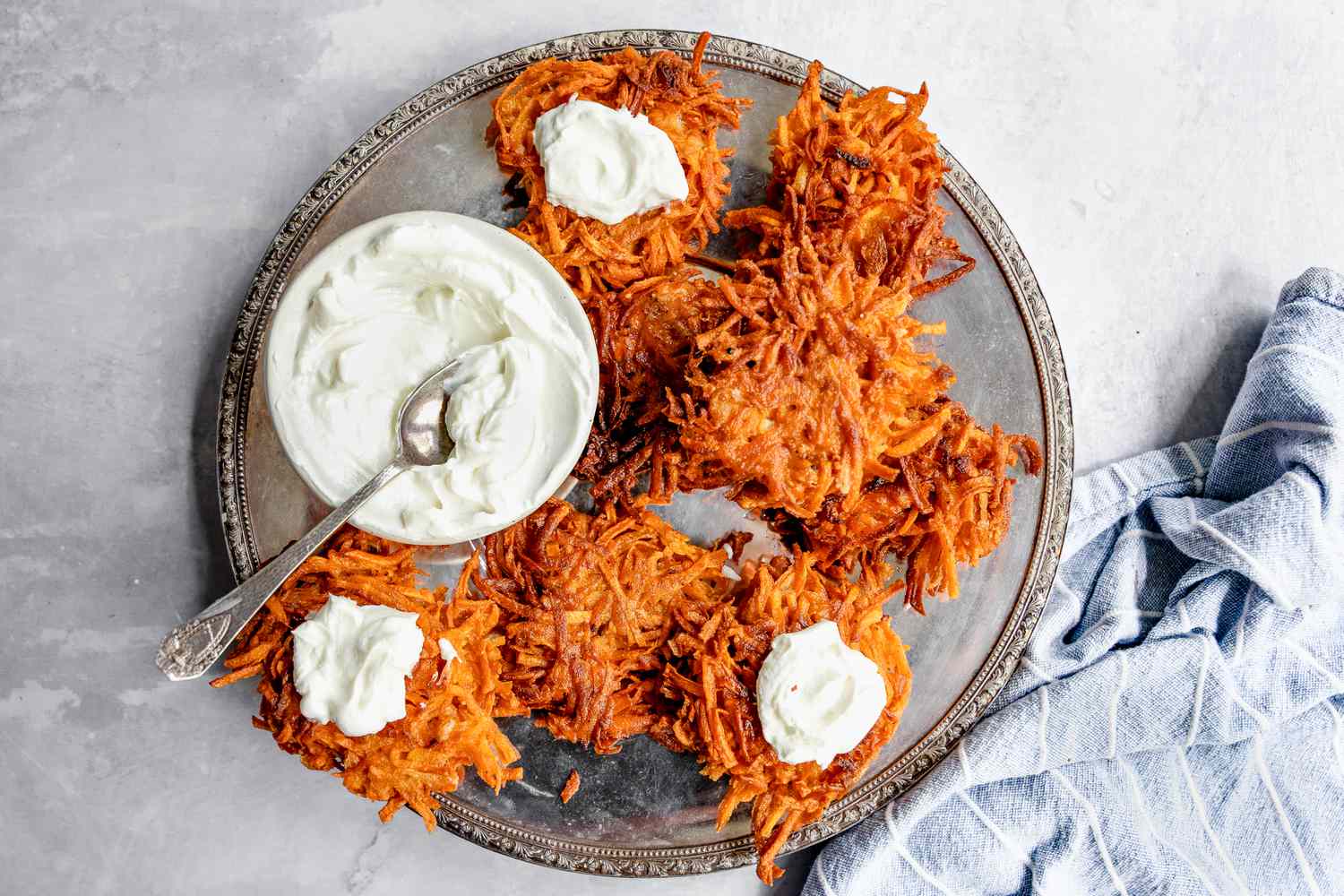 On a Silver Plate, Sweet Potato Latkes with Some Topped with Dollops of Sour Cream and a Small Bowl with More Sour Cream