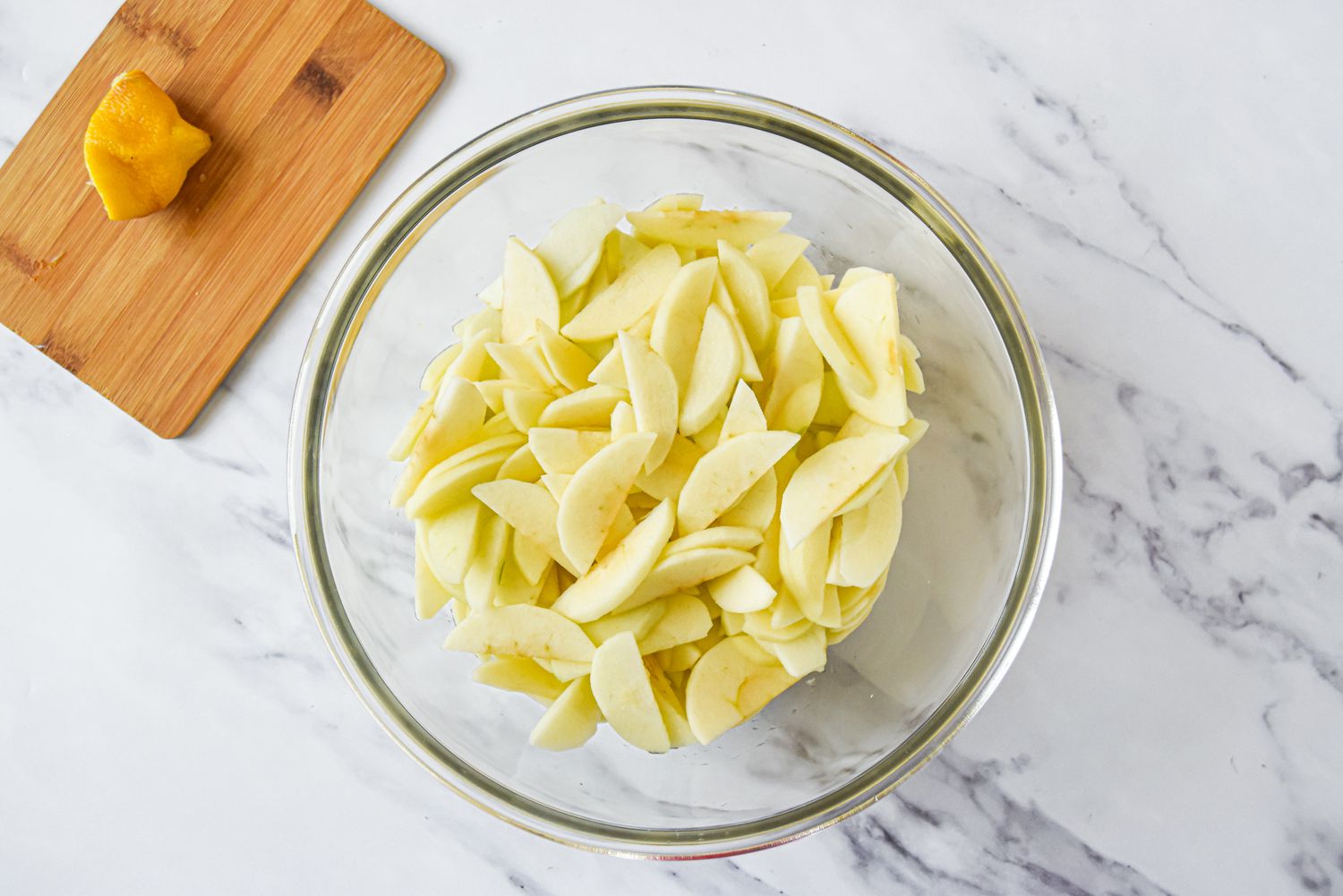 Apple Pieces with Lemon Juice in Bowl for Homemade Apple Pie Recipe