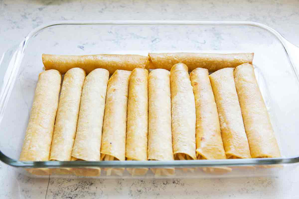 fill enchilada casserole dish with rolled tortillas