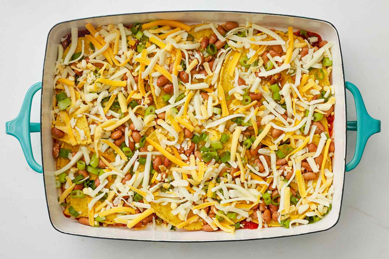Layers of huevos rancheros casserole in a casserole dish 