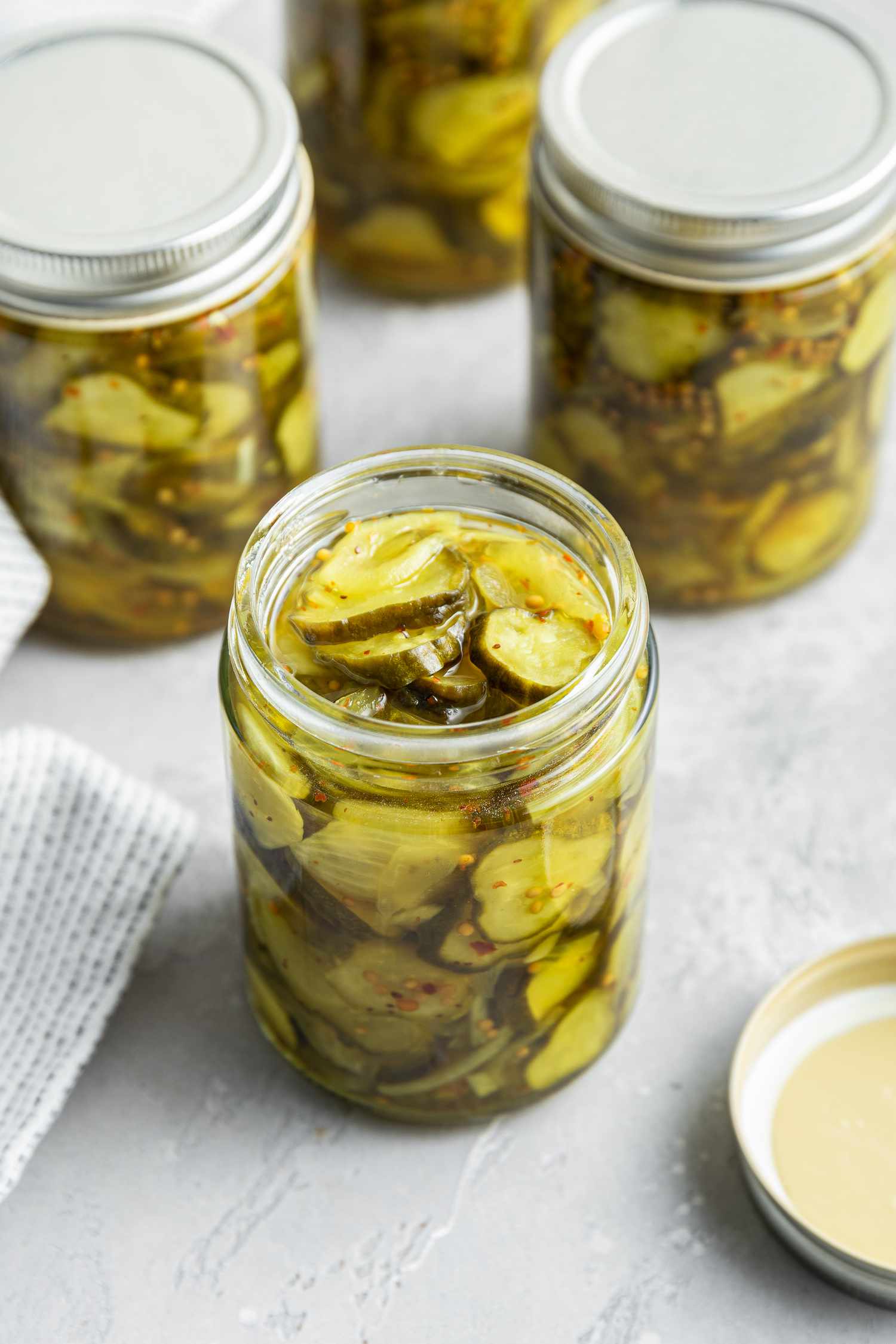Bread and Butter Pickles in Jars with One Jar Open