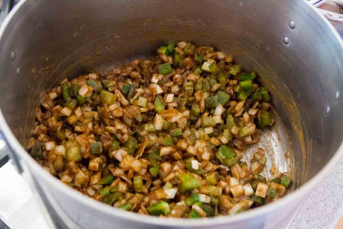 cook holy trinity of onions celery green pepper for green gumbo base