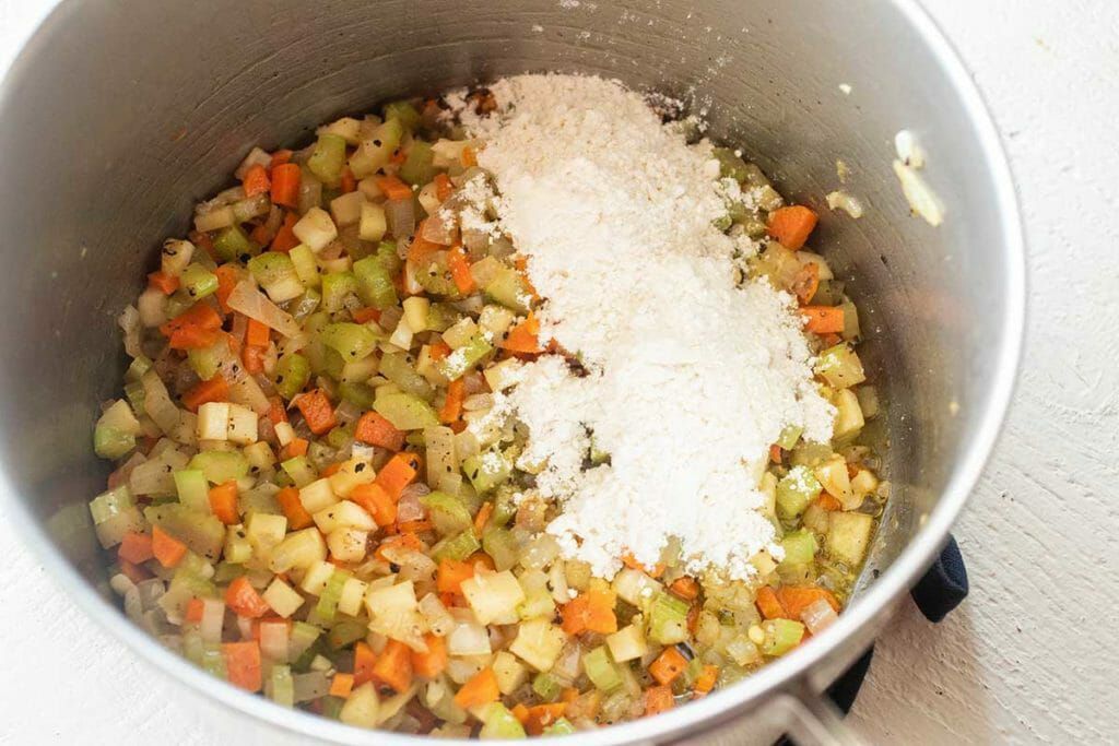 Saute vegetables in pot for creamy potato soup recipe
