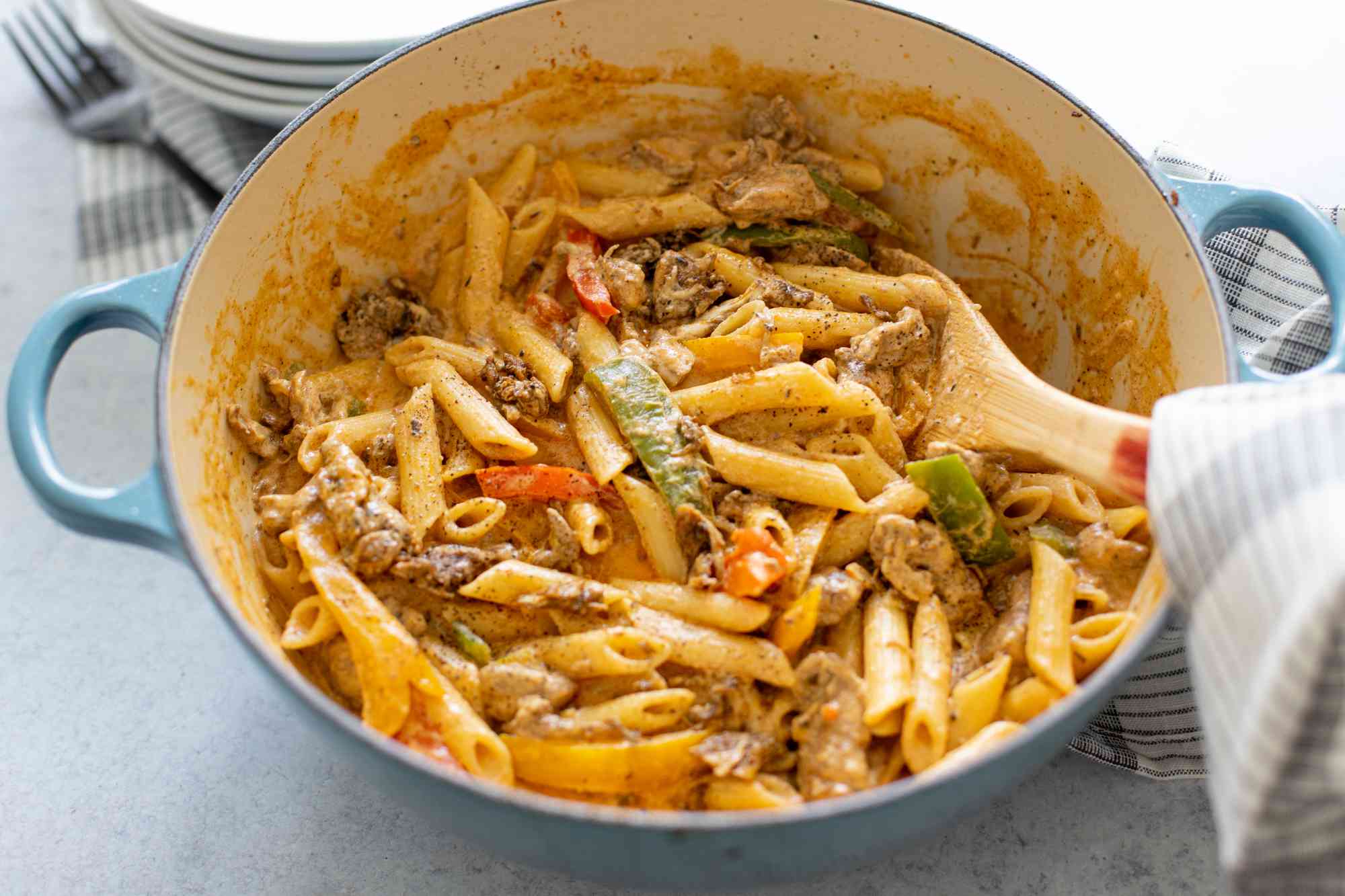 Rasta Pasta with Jerk Chicken in a Pot with a Serving Spoon