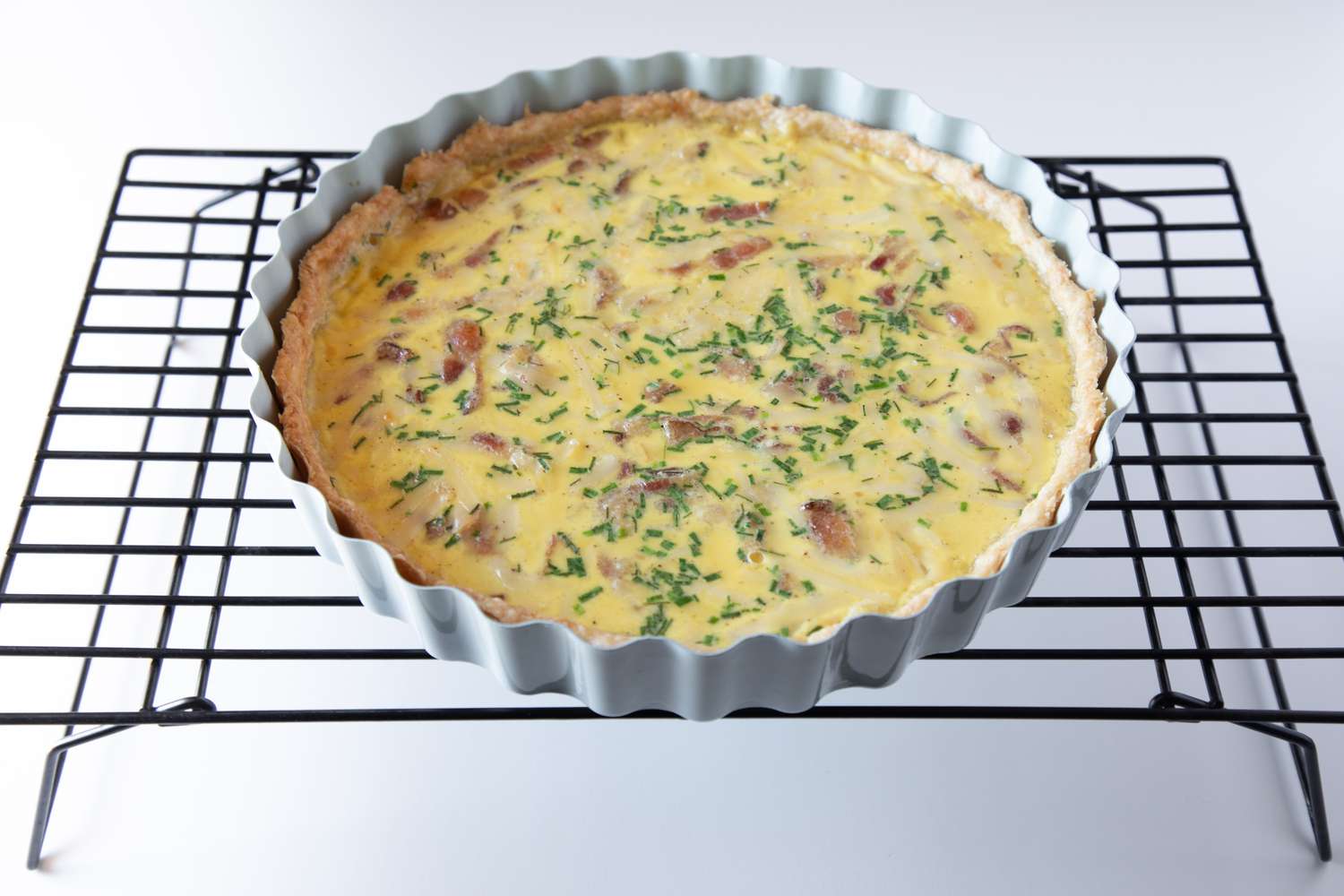 An easy quiche recipe cooling on a rack.