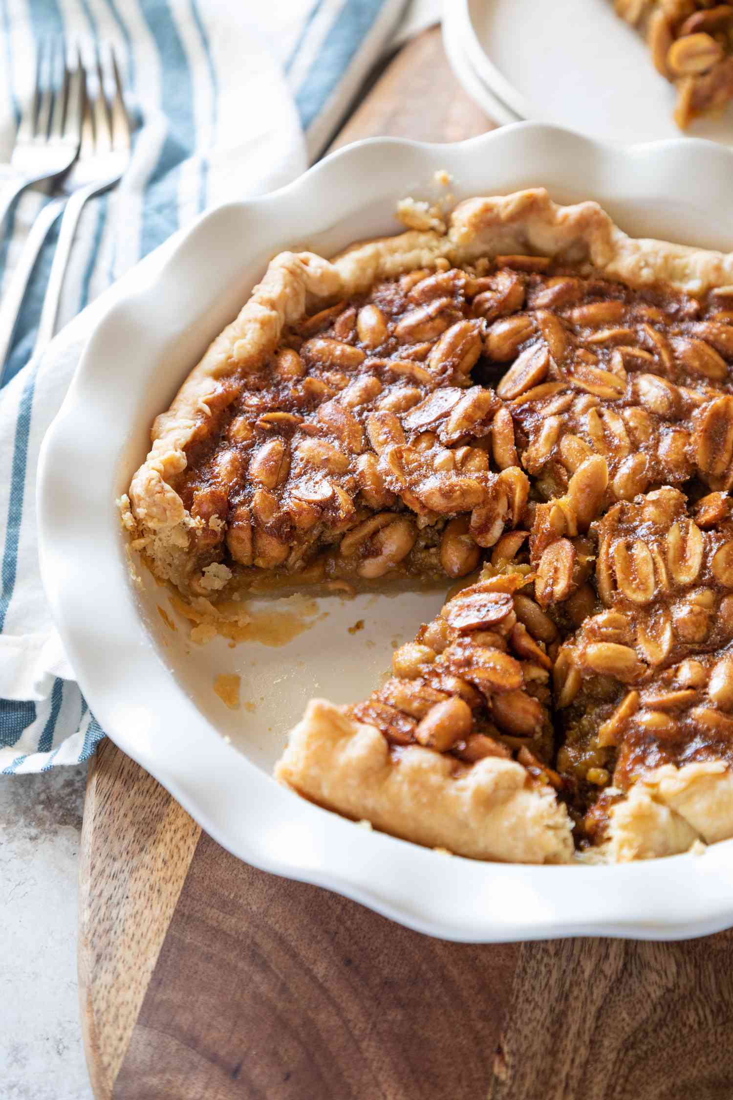Overhead view of a Southern Peanut Pie cut into slices in a ceramic pie plate.
