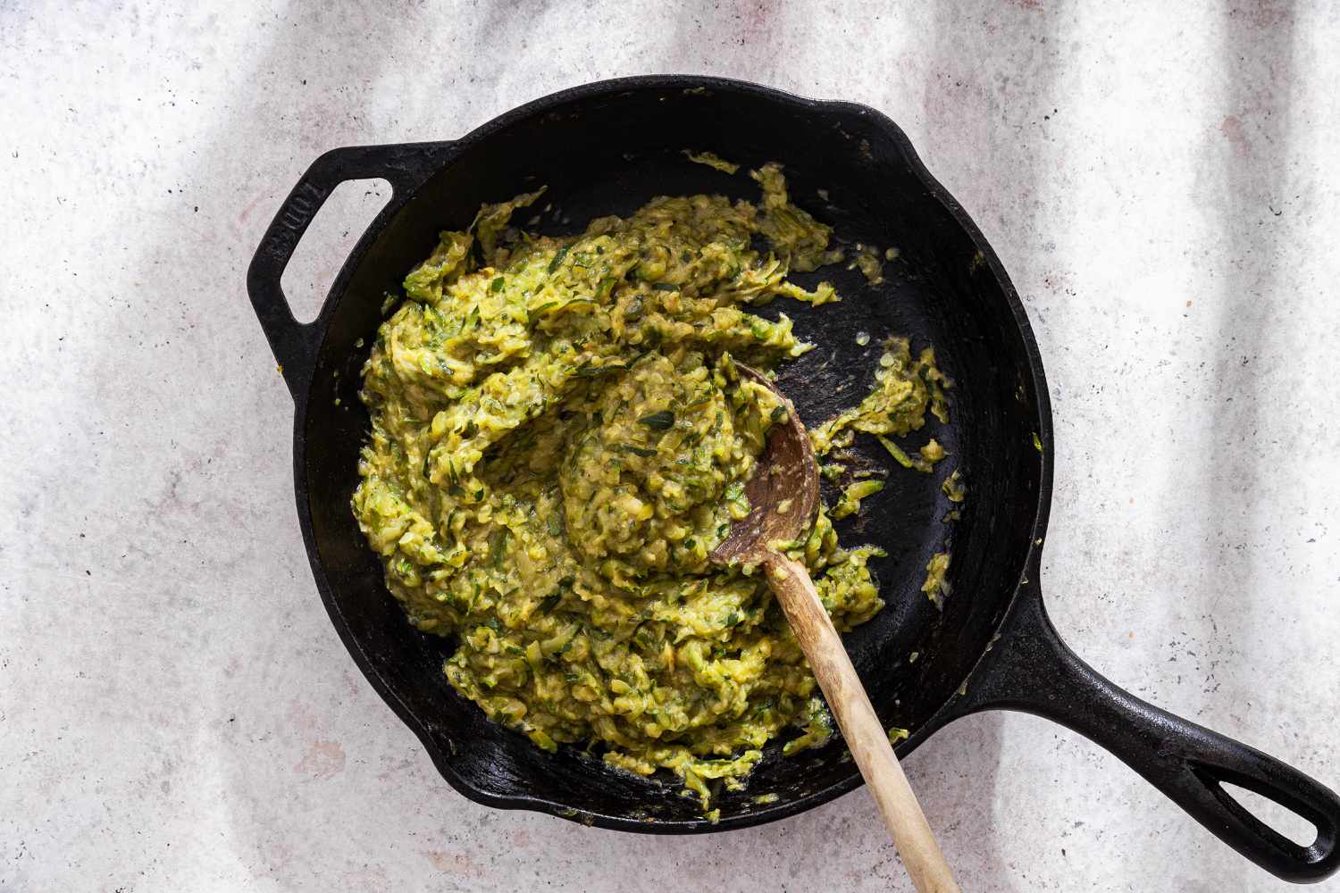 Shredded Zucchini Stirred and Reduced Even More in Cast Iron Skillet Until Desired Consistency