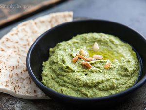 Basil Hummus in a bowl with pita on the side