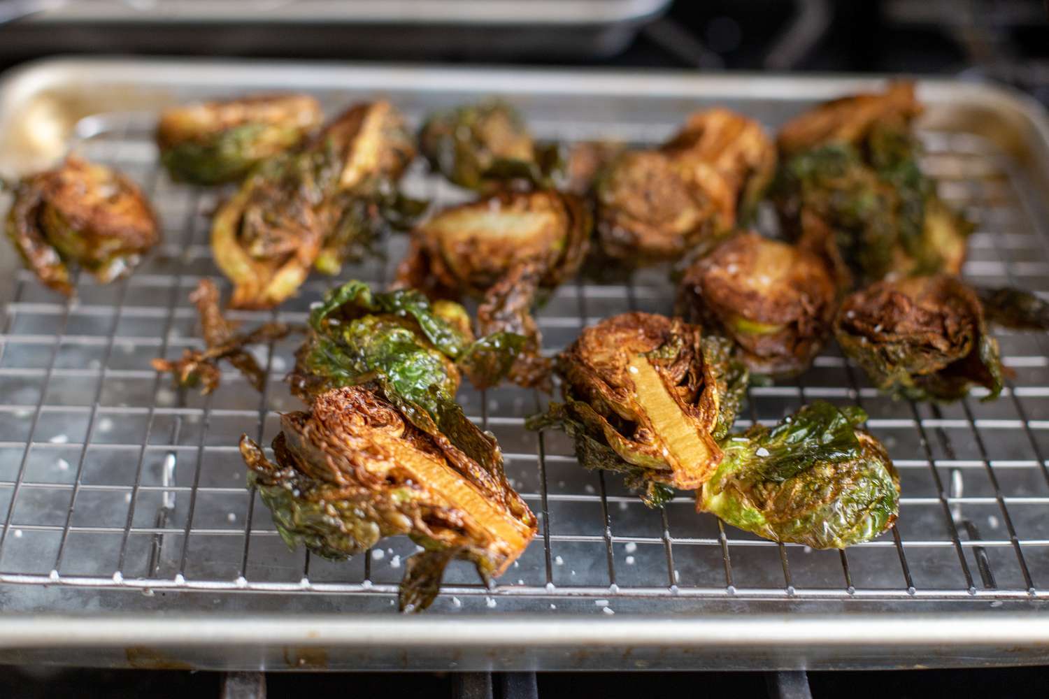 Deep Fried Brussel Sprouts Placed on a Cooling Rack over a Baking Sheet