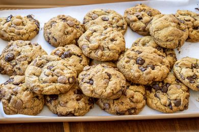 A tray of chocolate chip cookies arranged on a surface