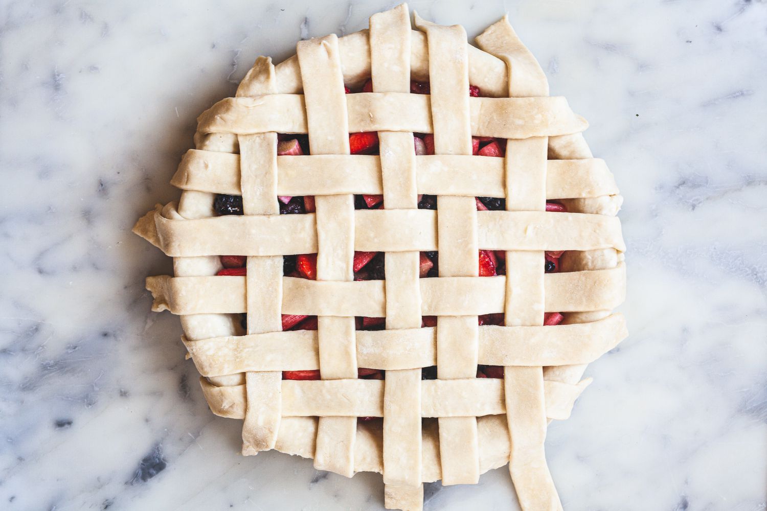 Weaving the strips of a lattice pie crust.