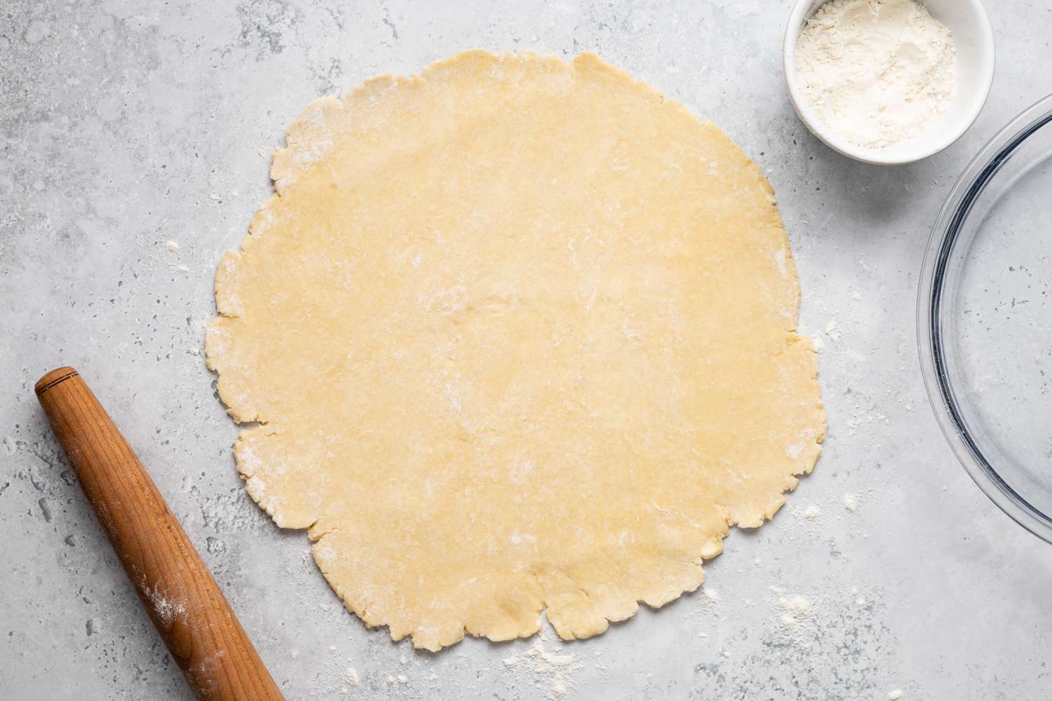 Pie Dough on Counter with Rolling Pin and Bowl of All-Purpose Flour
