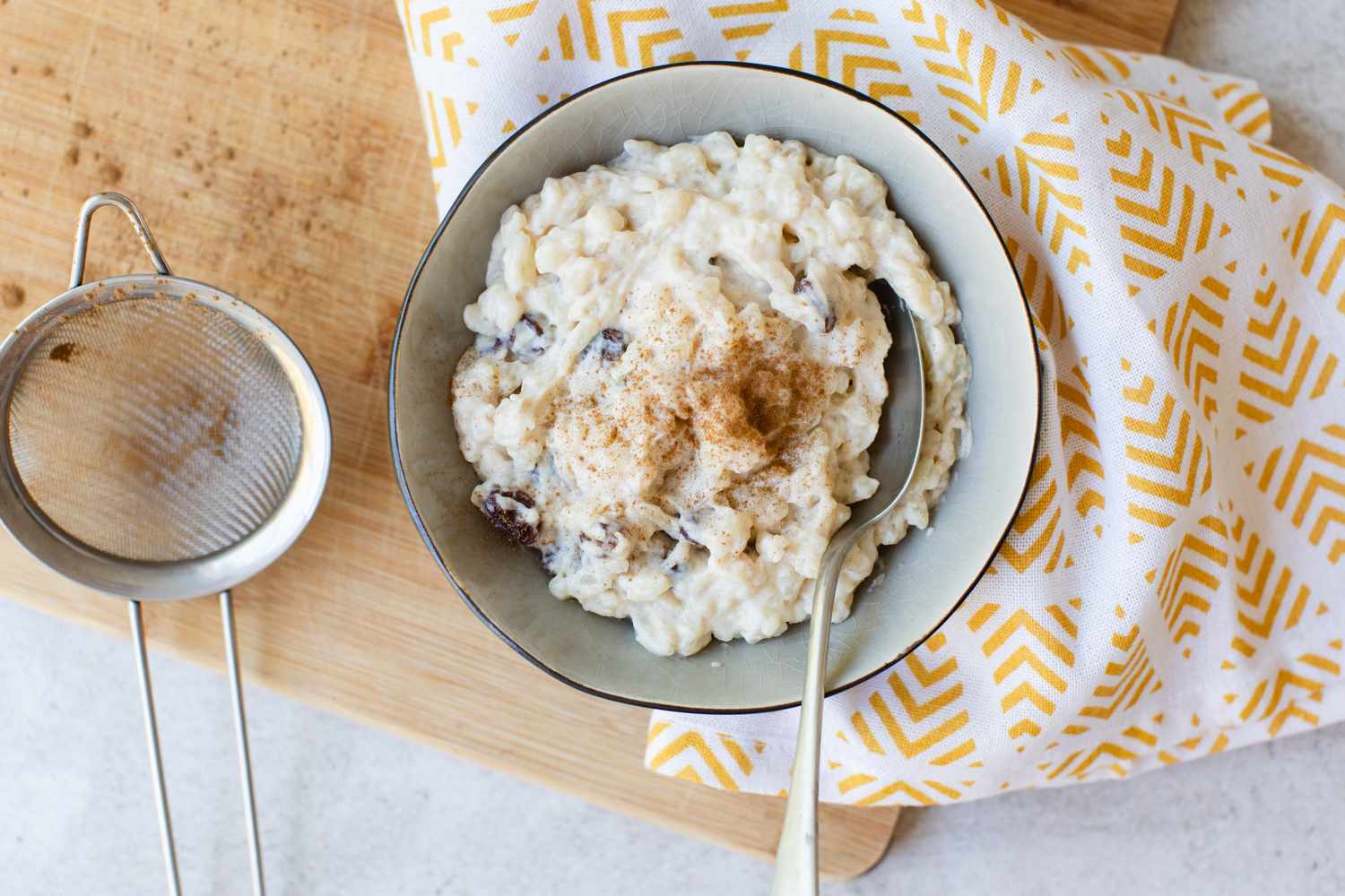 A bowl of Rice Pudding with cinnamon sprinkled on top
