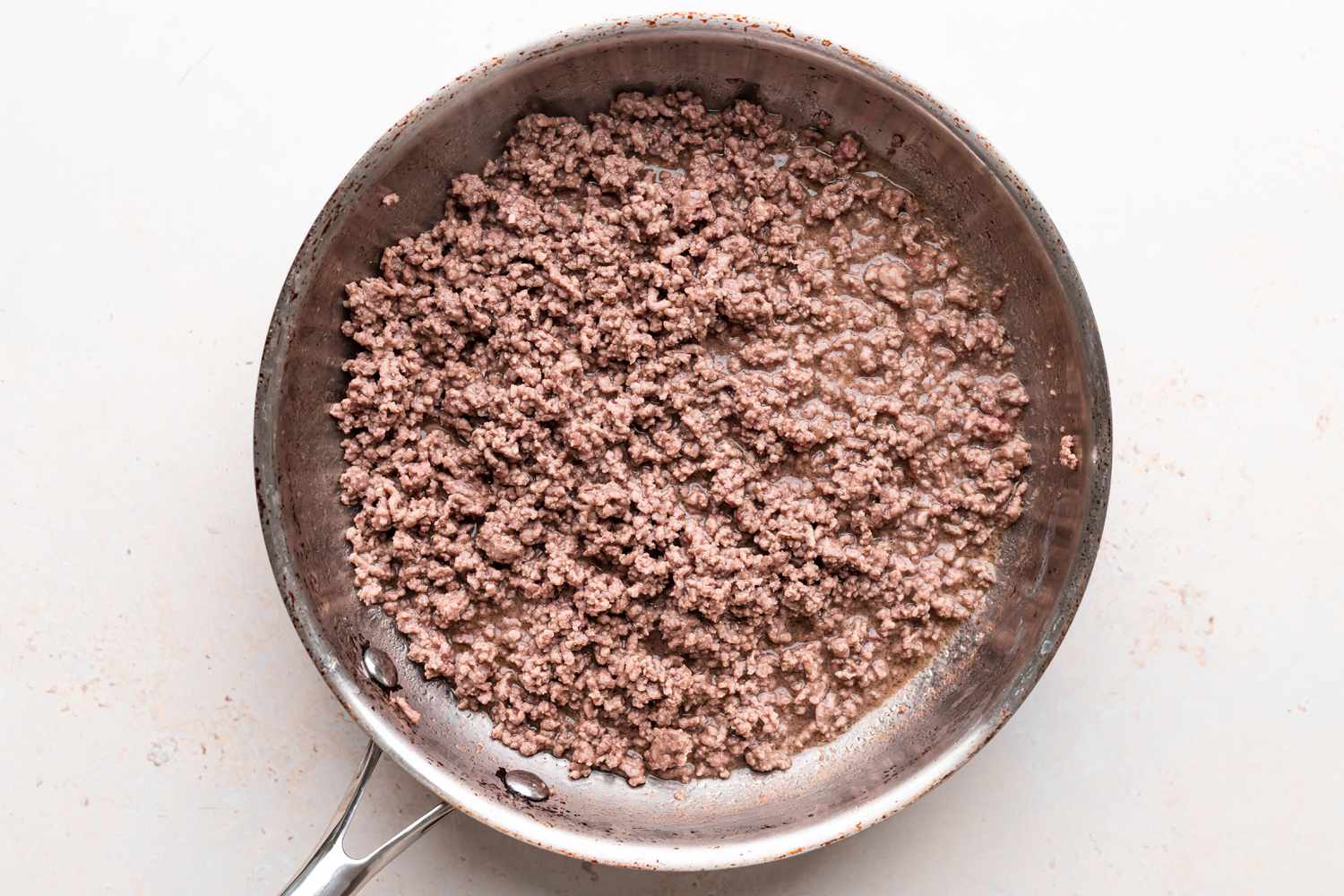 Browned beef in a skillet to make a lasagne recipe.