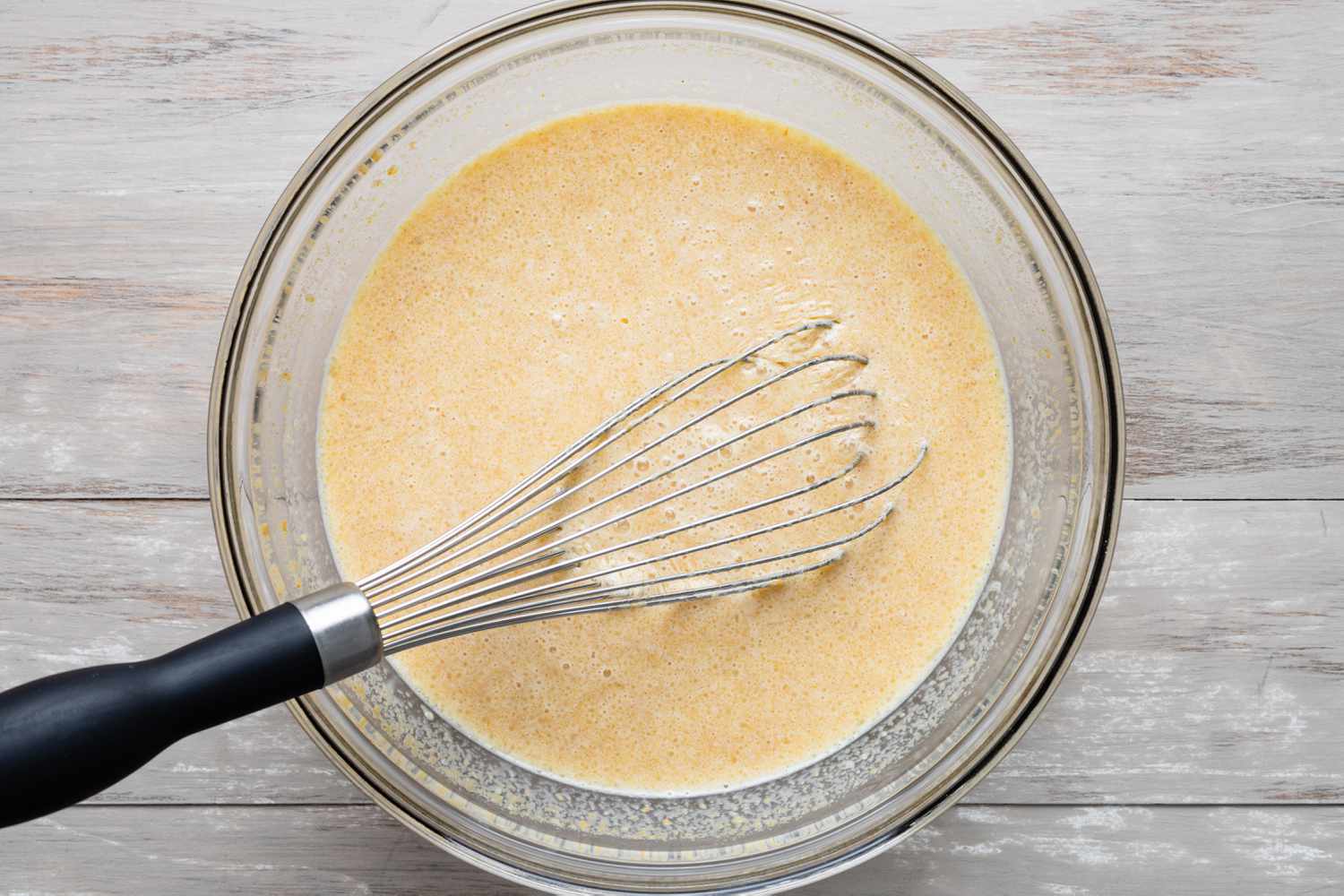 Wet Ingredients in a Bowl with a Whisk for Buckeye Pancakes