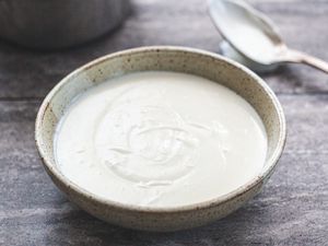 Side view of basic béchamel sauce in a bowl.