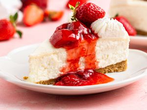 No-bake cheesecake slice on a plate with strawberry sauce on top