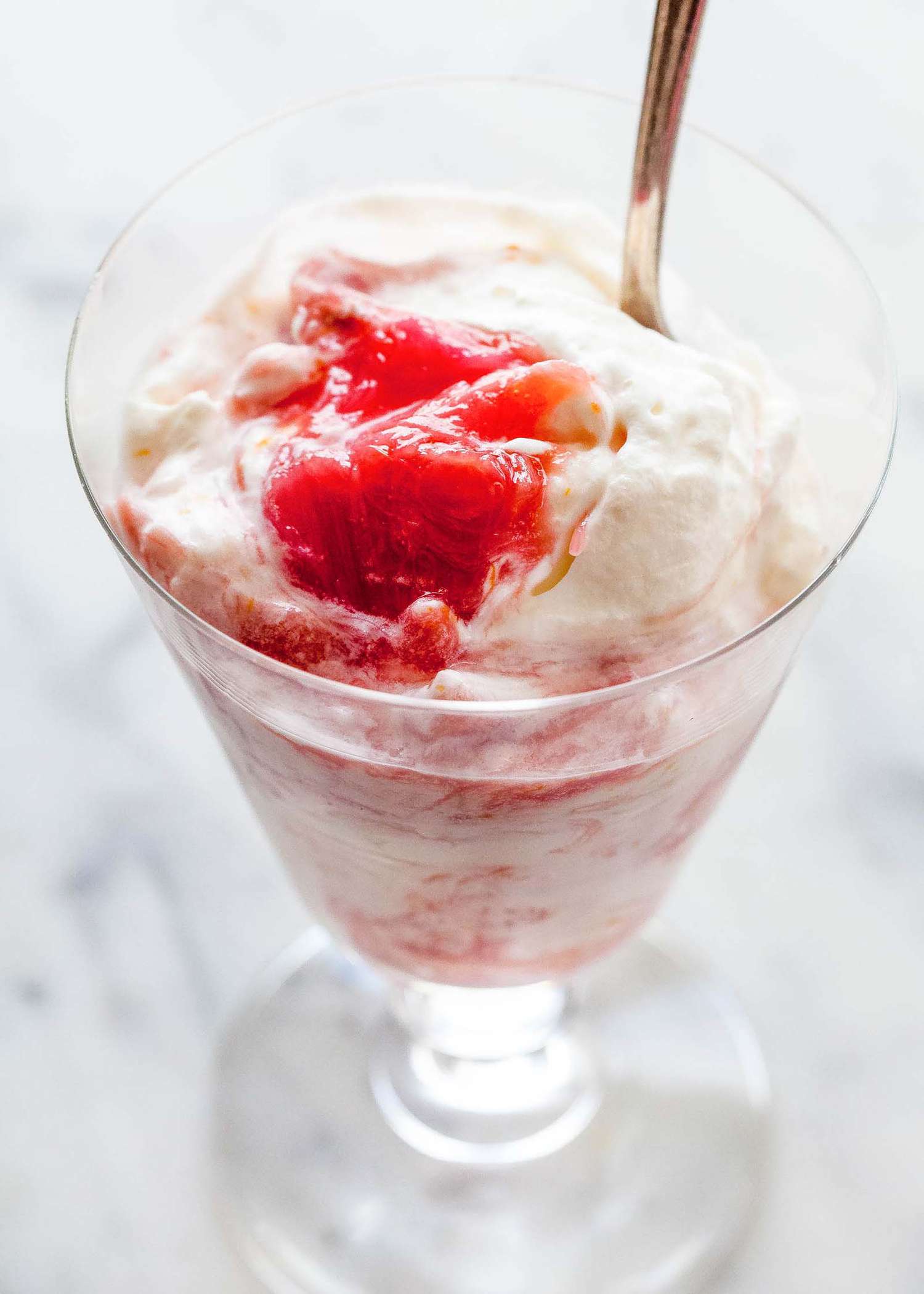 A top shot of rhubarb fool with a spoon ready to eat