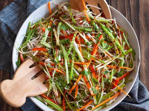 Overhead view of an easy rice noodle salad in a serving bowl along with wooden claws.
