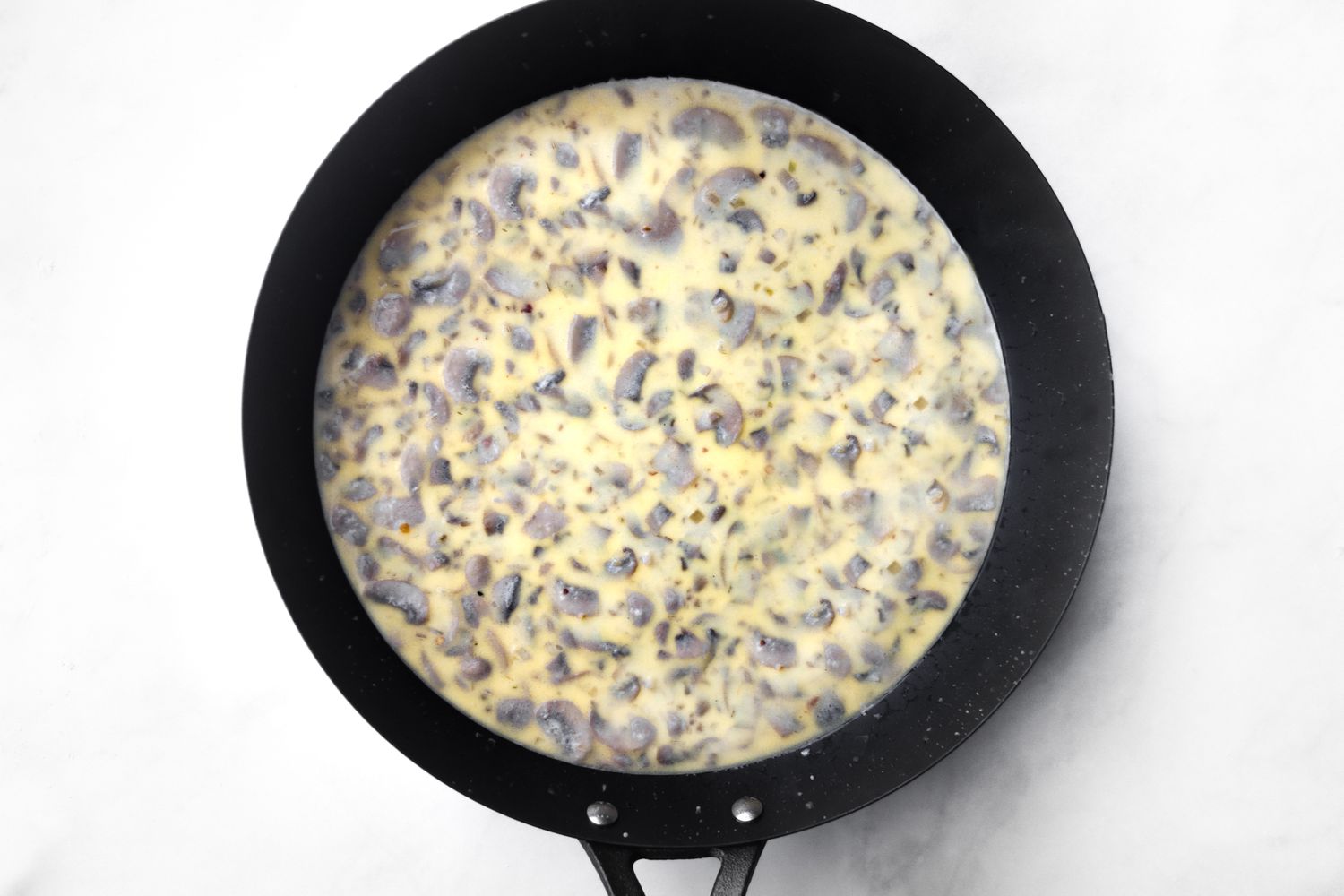 Add flour and milk to black skillet.