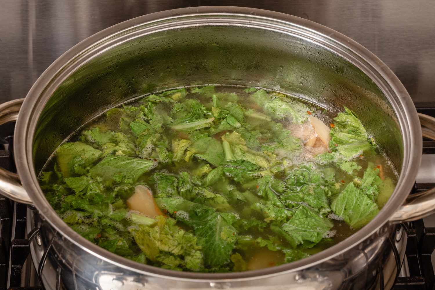 Hawaiian oxtail soup in a pot with greens ready to serve