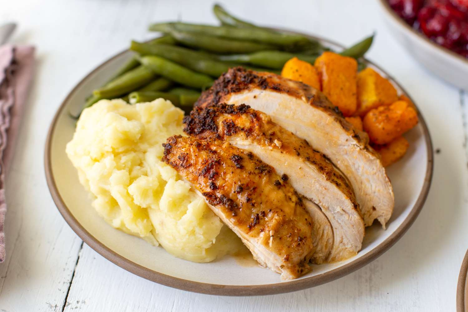 Simple instant pot turkey with gravy sliced and served on a plate with mashed potatoes and green beans.