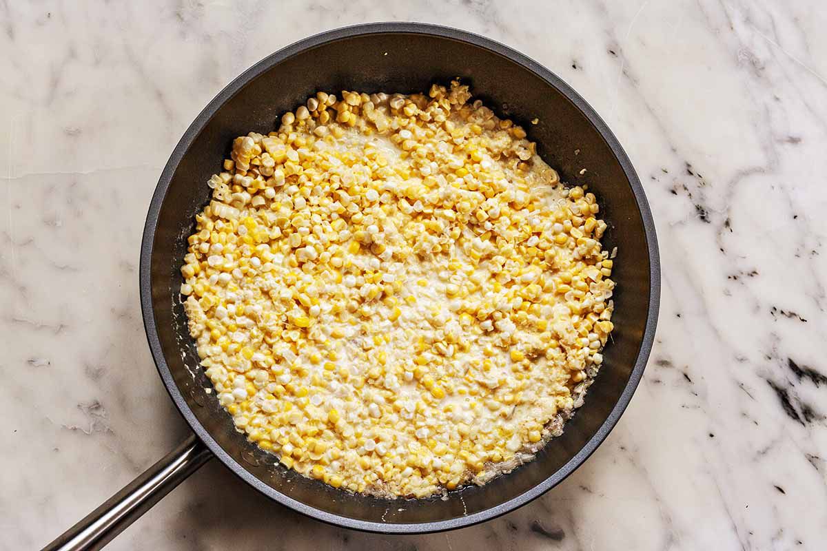 Creamed corn in a skillet.