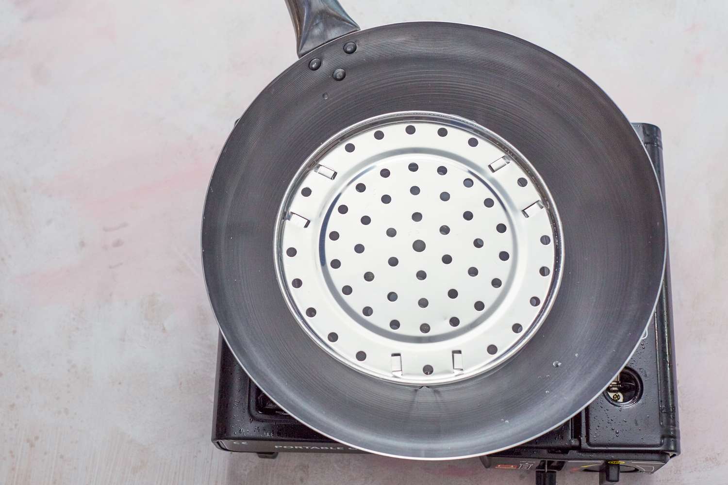 Setting up the steamer in a wok to make whole steamed fish.