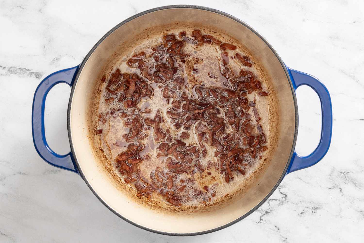 cooked bacon in a dutch oven for borracho beans (frijoles beans) recipe