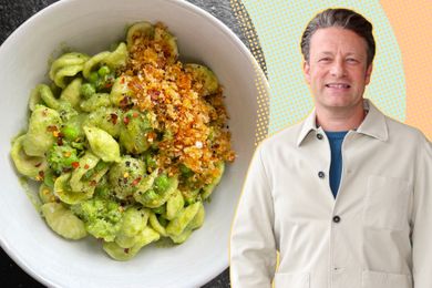 Jamie Oliver posed next to a bowl of green orecchiette pasta topped with breadcrumbs