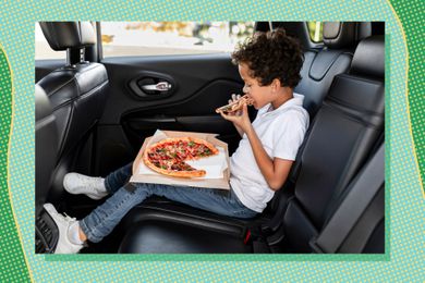Kid eating a pizza in car