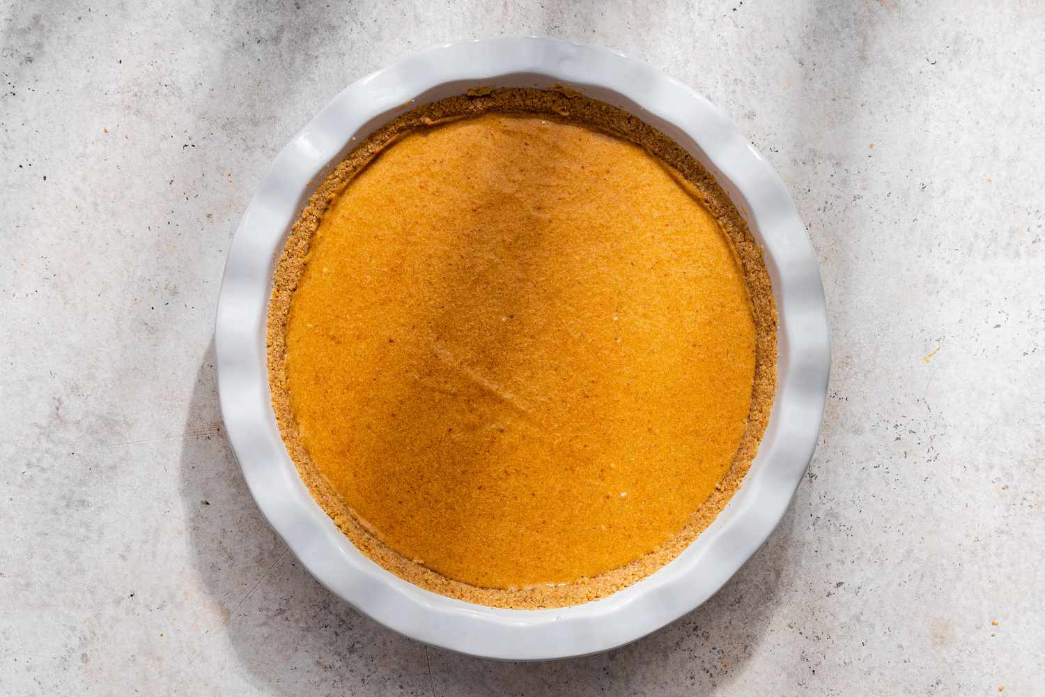 No-bake pumpkin pie filling added to graham cracker crust 