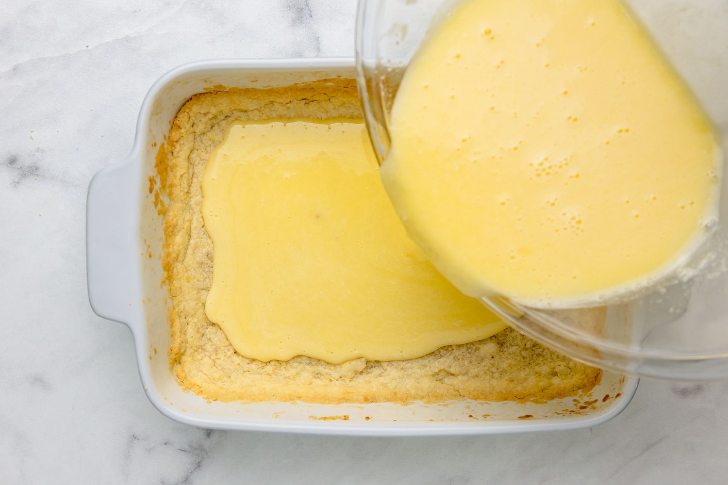 Lemon Bars Filling Poured into Baking Dish with Crust