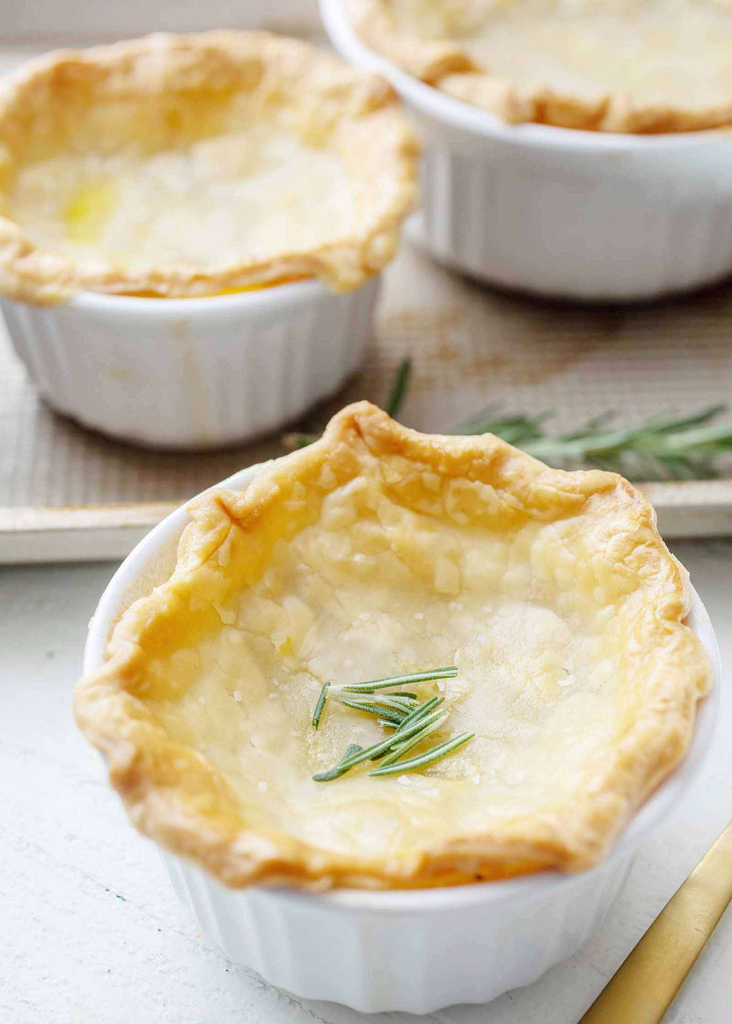 Small ramekin of leftover turkey pot pie with rosemary garnish