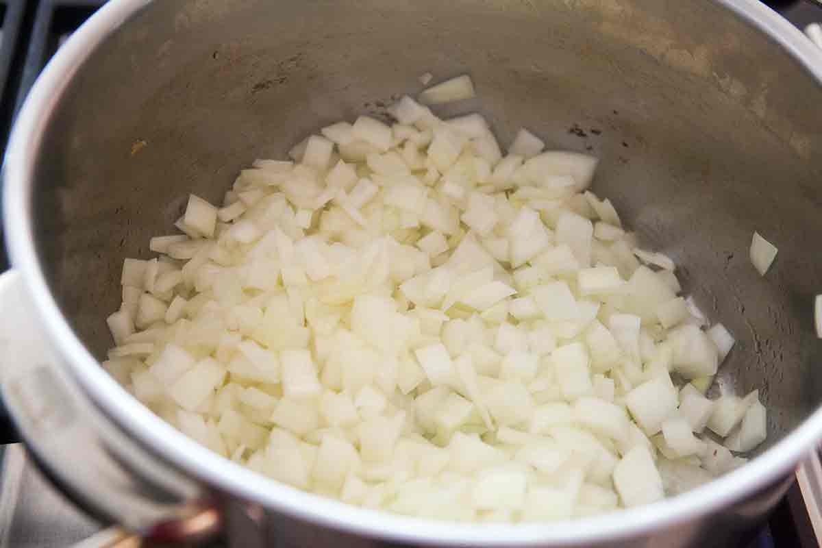 cook chopped onions in a pot for caramelized onion dip