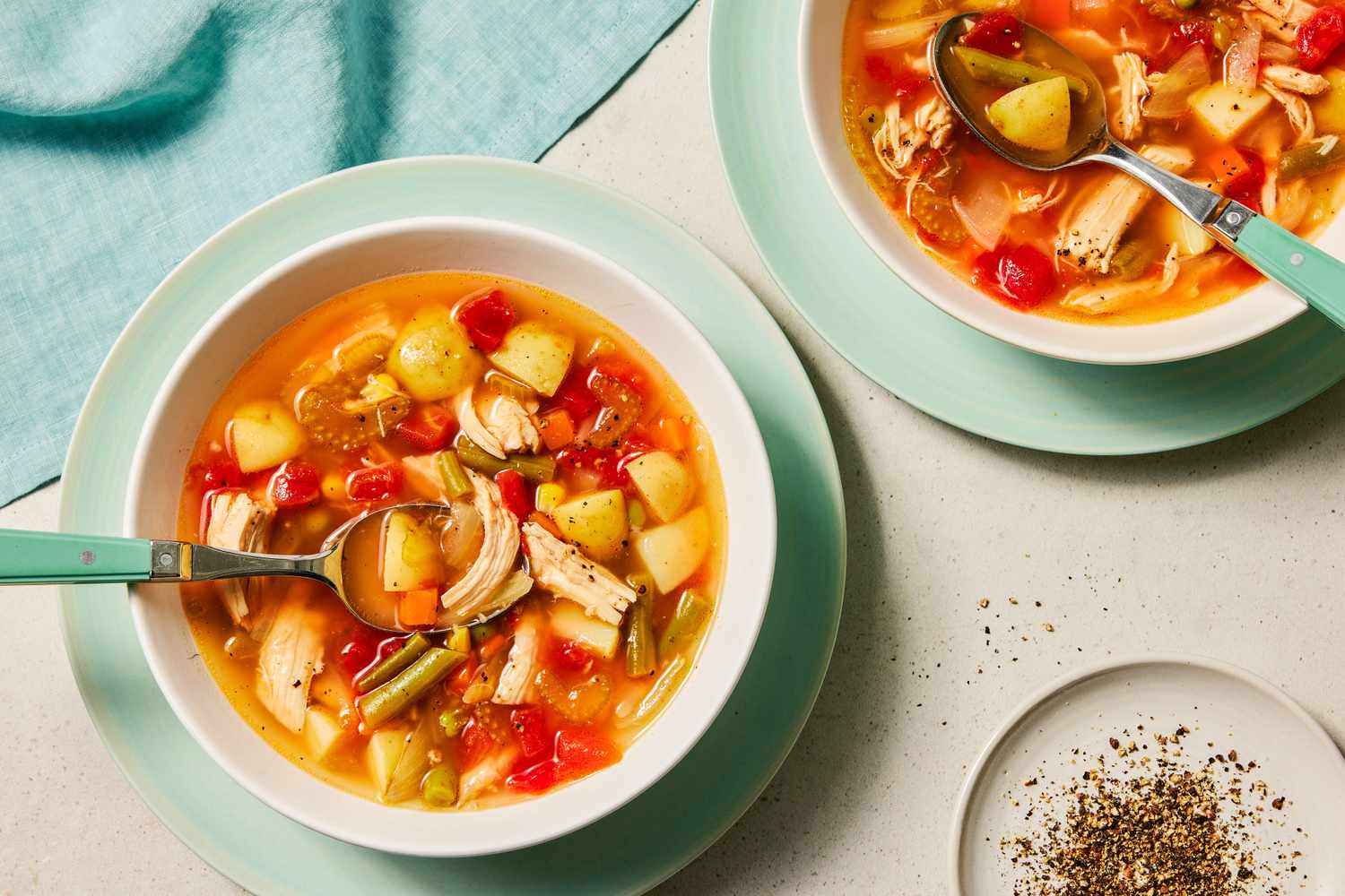 Chicken Vegetable Soup in two bowls with spoons