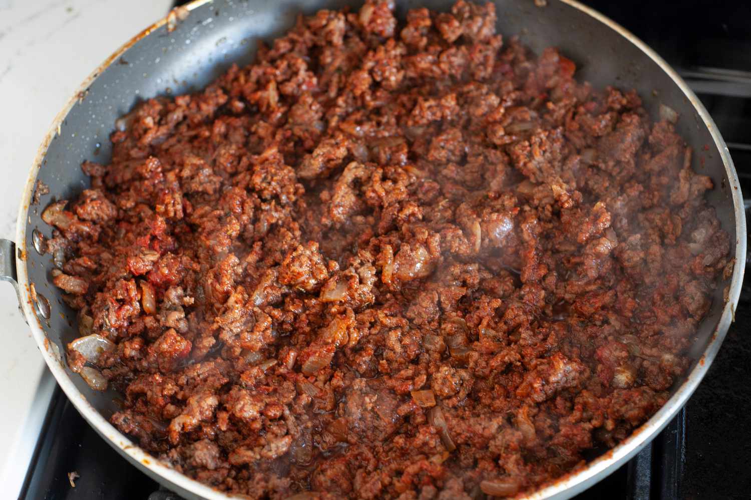 Meat Sauce in a Skillet over a Stove for Hawaiian Roll Sliders 