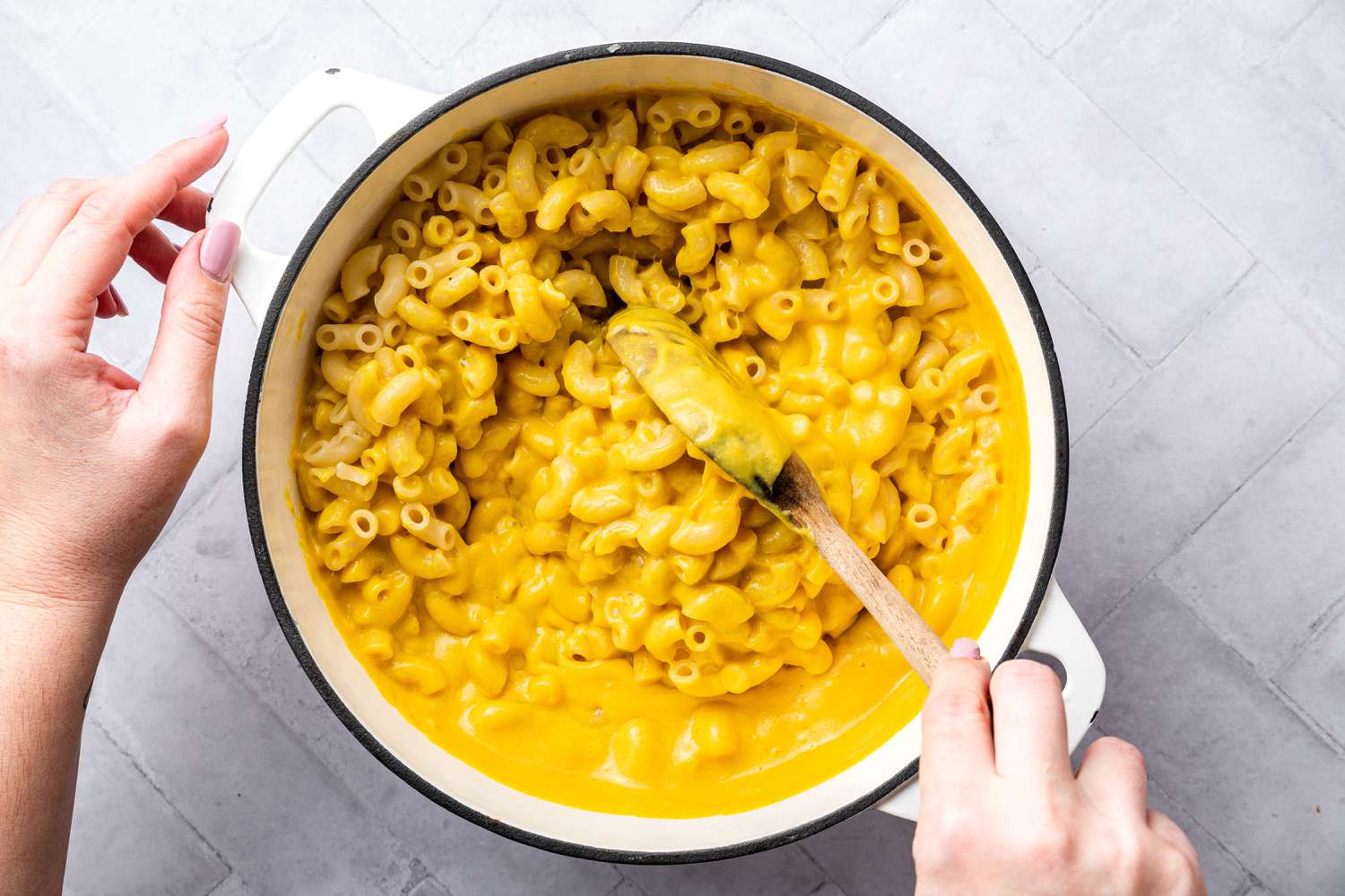 Vegan Mac and Cheese Mixed Together Using a Wooden Spoon