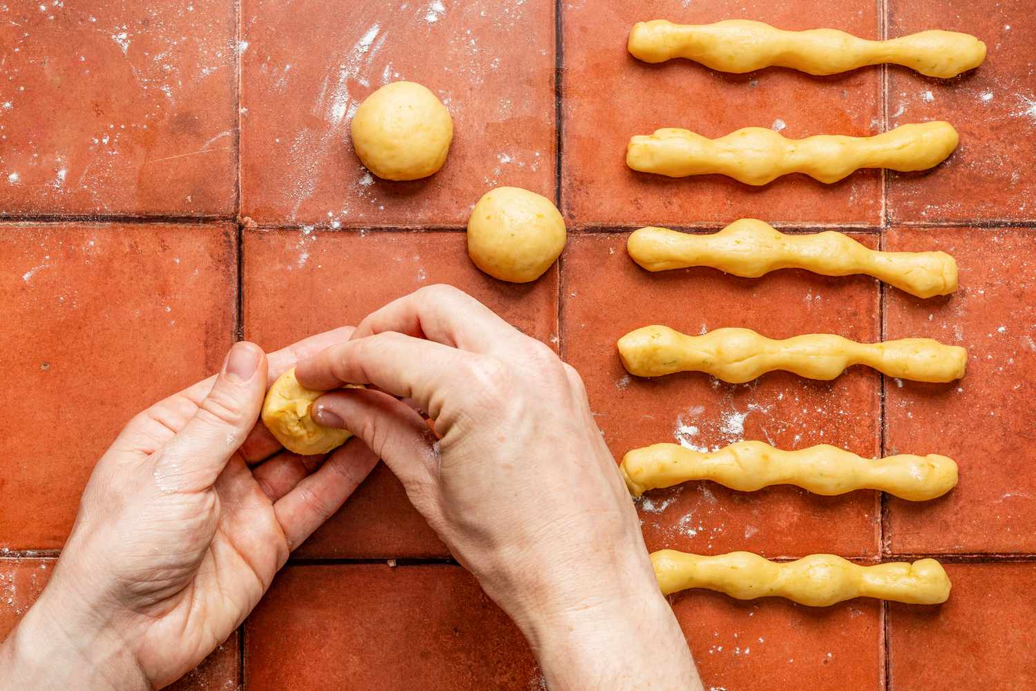 Leftover 3 dough portions formed into small balls (skeletons) for pan de muerto recipe