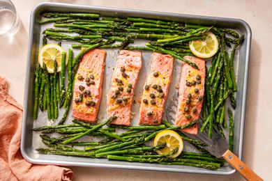 sheet pan salmon topped with lemon and capers next to asparagus