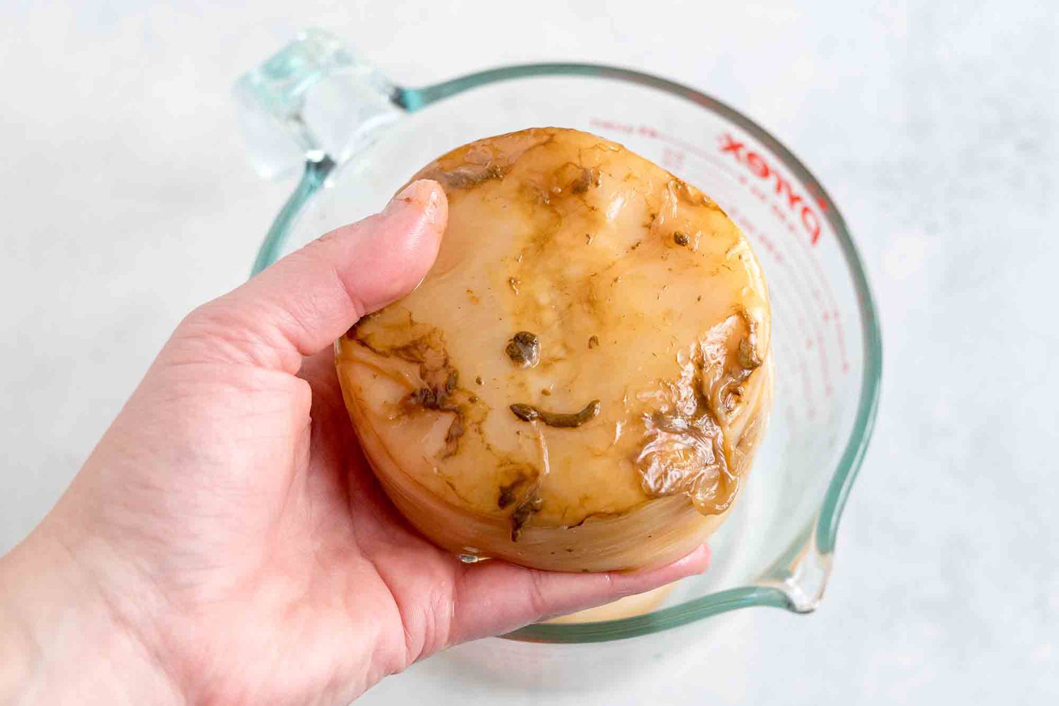 You might see or feel gritty slimy bits on the bottom; these are clumps of yeast and are ok.