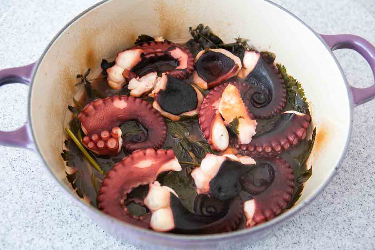baked octopus on herbs in pot