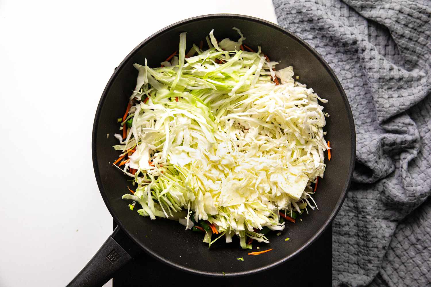 Shredded Cabbage Added to Wok with Other Pancit Bihon Ingredients 